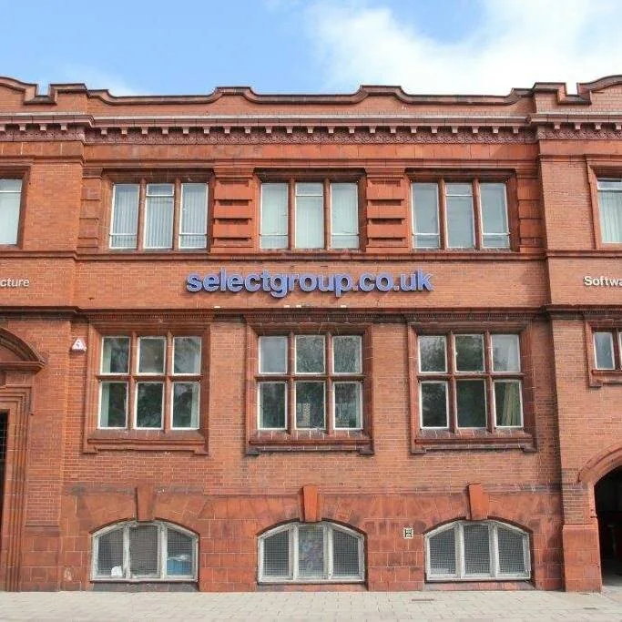 The Selectgroup office on Castle Street, a red brick Victorian building with selectgroup.co.uk in blue lettering across the first floor.